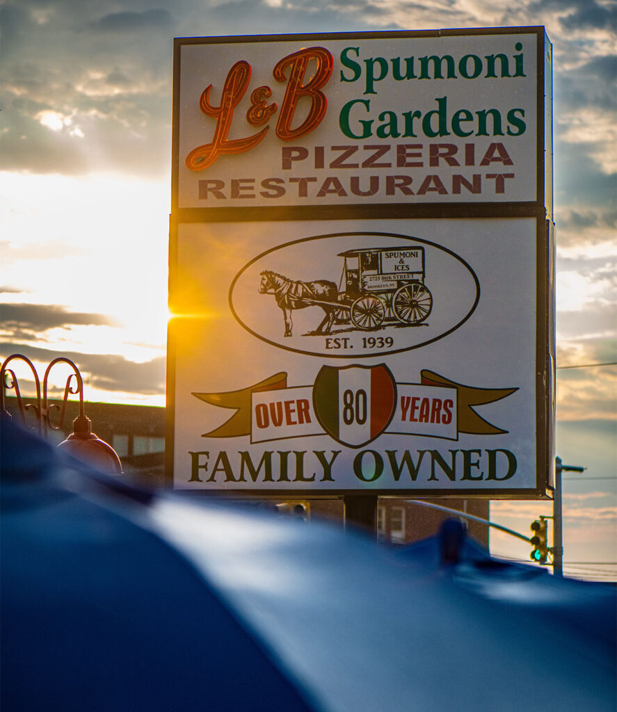 The iconic L&B Spumoni Gardens sign at sunset, family owned since 1939